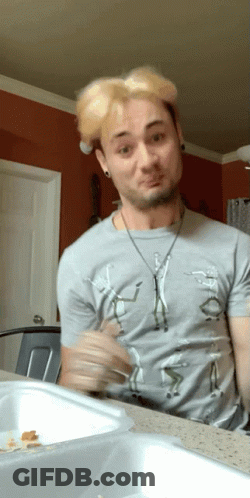 A Man Wearing A Gray Shirt With A Picture Of A Man On It Making A Funny Face GIF
