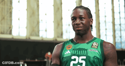 A Man Wearing A Green Adidas Jersey With The Number 25 On It GIF