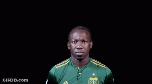 A Man Wearing A Green Adidas Shirt With A Star On It GIF