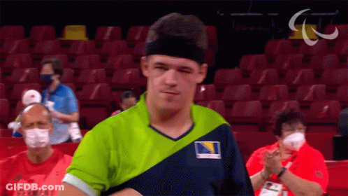 A Man Wearing A Green And Blue Shirt With Germany On The Front GIF