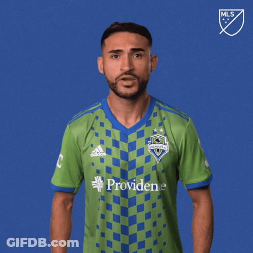 A Man Wearing A Green And Blue Shirt With The Word Vamos On It GIF