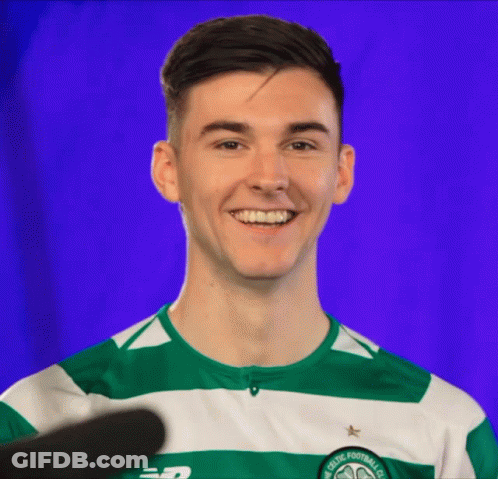 A Man Wearing A Green And White Striped Shirt That Says Celtic Football Club Smiles GIF