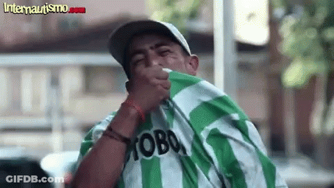 A Man Wearing A Green And White Striped Shirt With The Word Moba On It . GIF