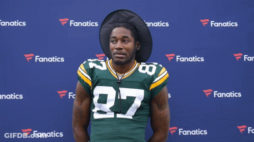 A Man Wearing A Green And Yellow Jersey With The Number 27 On It GIF