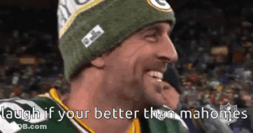 A Man Wearing A Green Bay Packers Hat Is Smiling And Laughing GIF