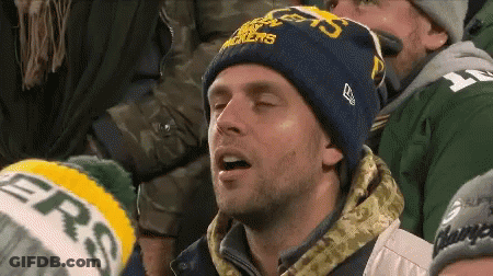 A Man Wearing A Green Bay Packers Hat Looks Tired GIF