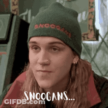 A Man Wearing A Green Beanie With The Words Snoogans On It GIF