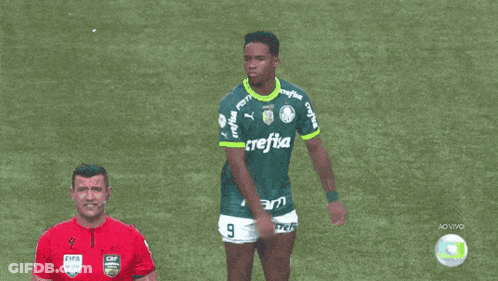 A Man Wearing A Green Crefisa Jersey Stands On A Soccer Field GIF