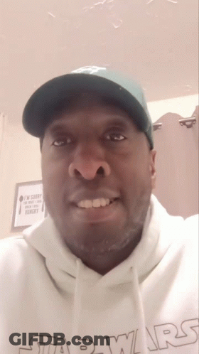 A Man Wearing A Green Hat And A White Star Wars Hoodie GIF