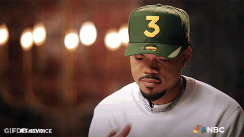 A Man Wearing A Green Hat With The Number Three On It GIF