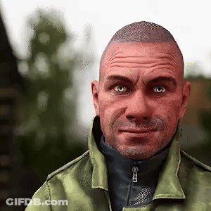 A Man Wearing A Green Jacket And A Black Turtleneck Is Looking At The Camera . GIF