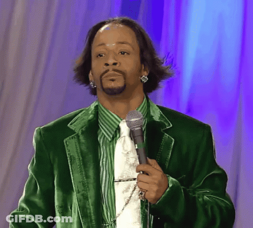 A Man Wearing A Green Jacket And Tie Is Holding A Microphone GIF