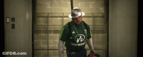 A Man Wearing A Green Leatherman Shirt And A Hard Hat GIF
