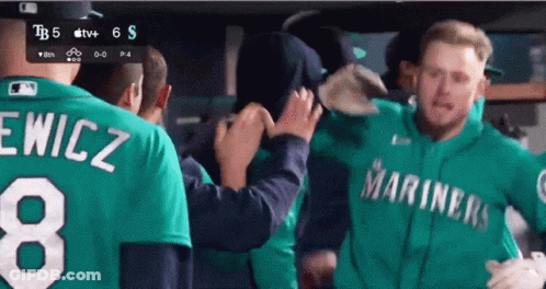 A Man Wearing A Green Mariners Jersey With The Number 8 On It GIF