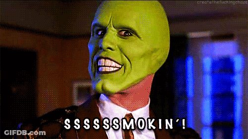 A Man Wearing A Green Mask And A Suit Says Sssss Smokin ' GIF