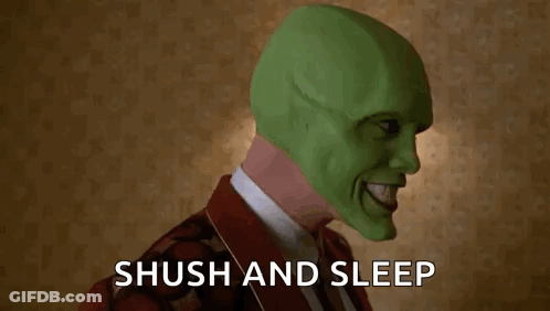 A Man Wearing A Green Mask Is Holding His Finger To His Mouth And Says Shush And Sleep . GIF