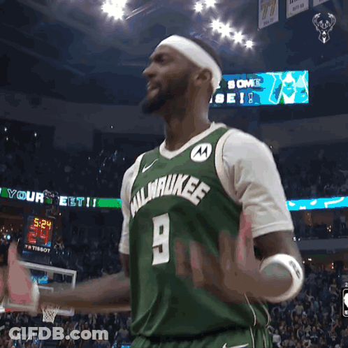 A Man Wearing A Green Milwaukee Jersey With The Number 9 GIF