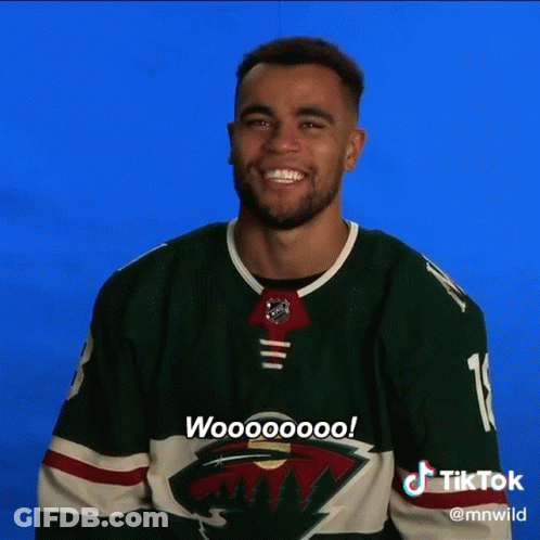 A Man Wearing A Green Minnesota Wild Jersey Says Woooooo GIF