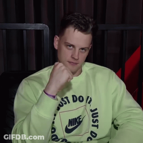 A Man Wearing A Green Nike Sweatshirt Has His Fist Up GIF