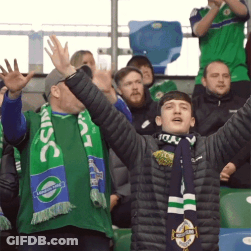 A Man Wearing A Green Scarf That Says Lsc On It GIF