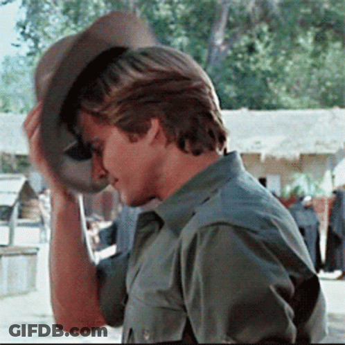 A Man Wearing A Green Shirt And A Cowboy Hat GIF