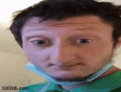 A Man Wearing A Green Shirt And A Face Mask GIF