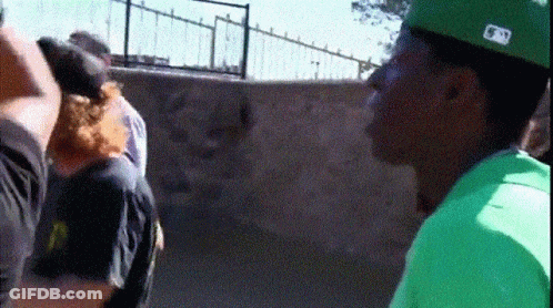 A Man Wearing A Green Shirt And A Hat With The Letter N On It GIF