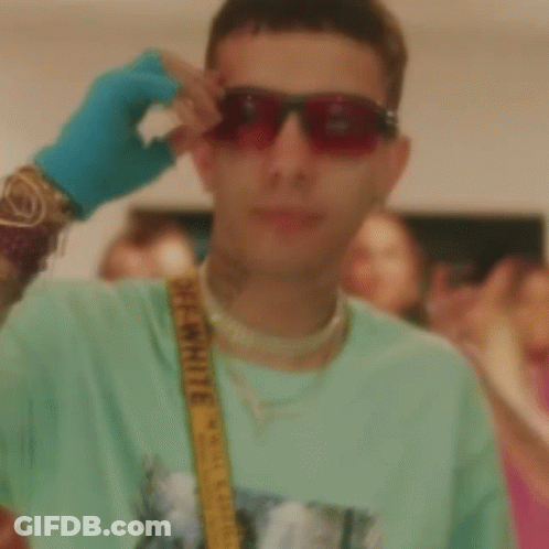 A Man Wearing A Green Shirt And A Yellow Belt With The Word Off White On It GIF