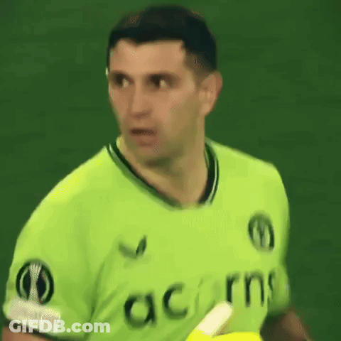 A Man Wearing A Green Shirt That Says Acorns On The Front GIF