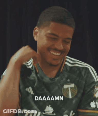 A Man Wearing A Green Shirt That Says Daaaamn On It GIF