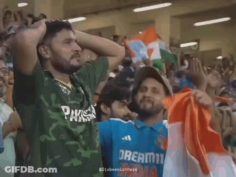 A Man Wearing A Green Shirt That Says Pakistan Is Standing Next To Another Man Wearing A Blue Shirt That Says Dream11 In GIF