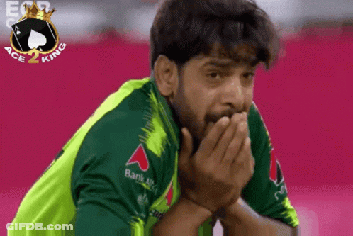 A Man Wearing A Green Shirt With A Bank Logo On The Sleeve GIF