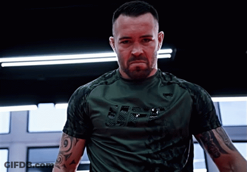 A Man Wearing A Green Shirt With The Word Ufc On It GIF