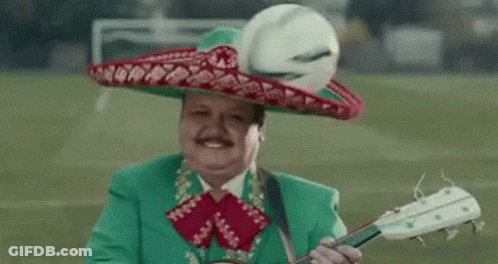 A Man Wearing A Green Suit And Sombrero Is Playing A Guitar . GIF
