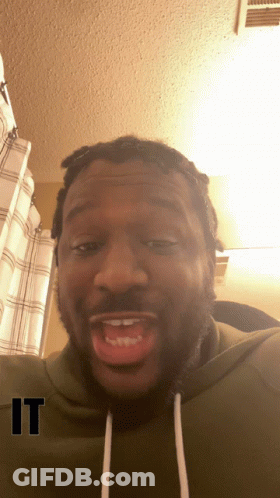 A Man Wearing A Green Sweatshirt With The Word " It " On The Bottom GIF