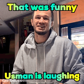 A Man Wearing A Grey Nike Hoodie Is Laughing With A Caption That Says That Was Funny Usman Is Laughing GIF