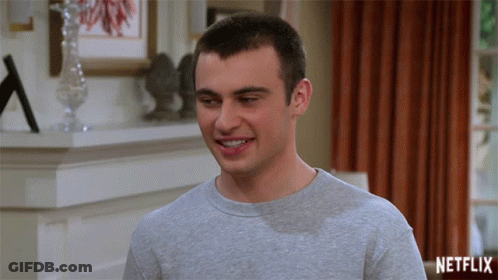 Man Smiling In Front Of Netflix Logo GIF