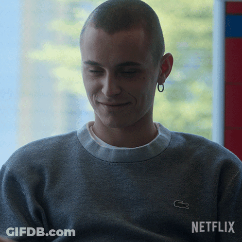 A Man Wearing A Grey Sweater With A White Lacoste Logo GIF