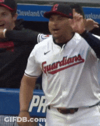 A Man Wearing A Guardians Jersey Stands In Front Of A Dugout GIF