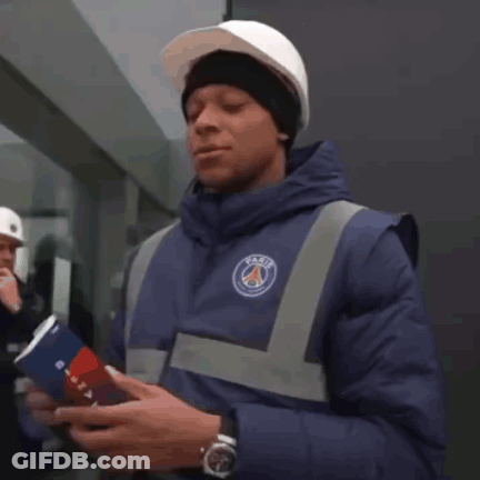 A Man Wearing A Hard Hat And A Blue Jacket With The Word Paris On It GIF