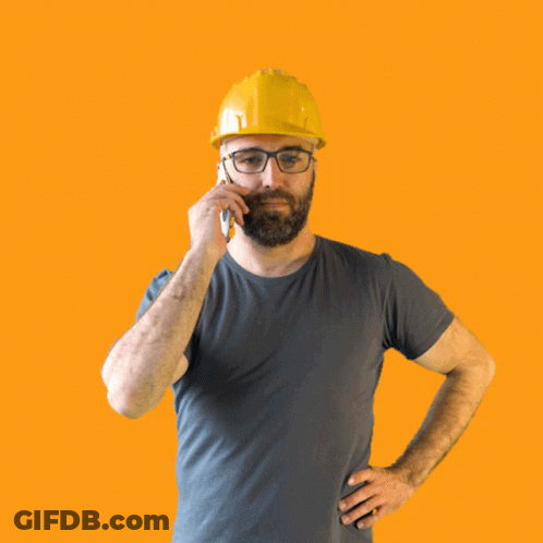 A Man Wearing A Hard Hat And Glasses Talking On A Cell Phone GIF