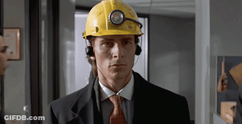A Man Wearing A Hard Hat And Headphones Looks Serious GIF