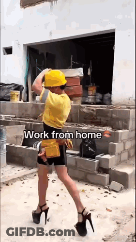 A Man Wearing A Hard Hat And High Heels Is Carrying Bricks . GIF