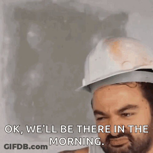 A Man Wearing A Hard Hat Is Saying Ok We 'Ll Be There In The Morning GIF