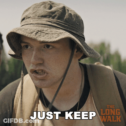 A Man Wearing A Hat And A Backpack Says " Just Keep " GIF