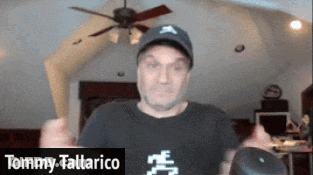 A Man Wearing A Hat And A Black Shirt Is Named Tommy Tallarico GIF