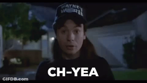 A Man Wearing A Hat And A Black Shirt Is Standing In Front Of A House And Saying `` Ch-Yea '' . GIF