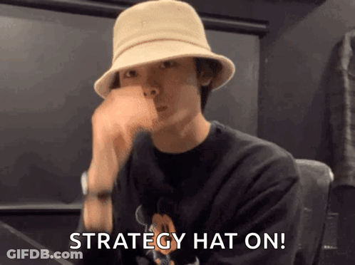 Man In Black Shirt And Hat Says Strategy Hat On GIF