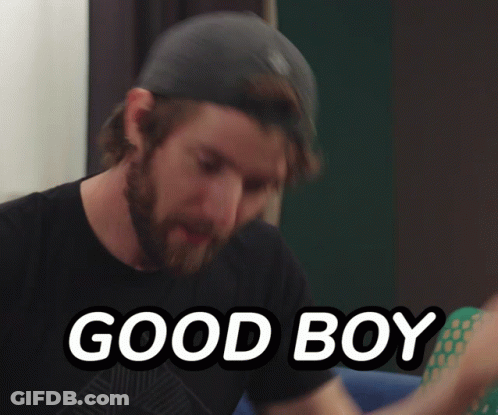 A Man Wearing A Hat And A Black Shirt With The Words Good Boy Below Him GIF