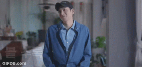 A Man Wearing A Hat And A Blue Jacket Is Smiling GIF